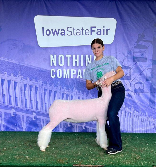Junior livestock show family with lamb